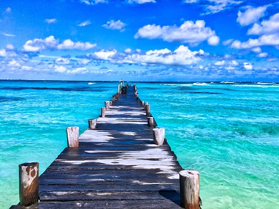 image of pier out over mexico water and beach